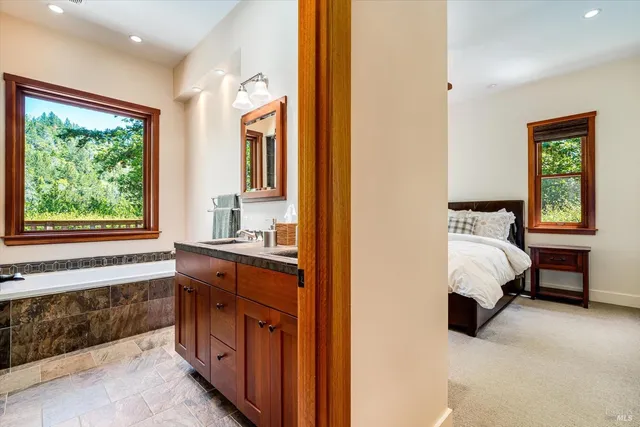 a bedroom with a bed and a large window