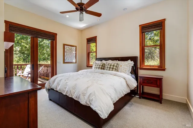 a large bed sitting in a bedroom next to a window