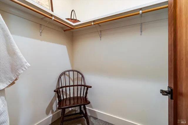 a view of staircase with a metal railing and a shower