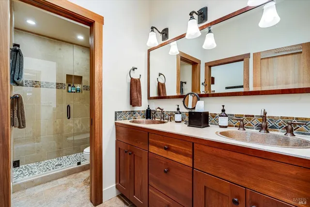 a bathroom with a shower sink and mirror