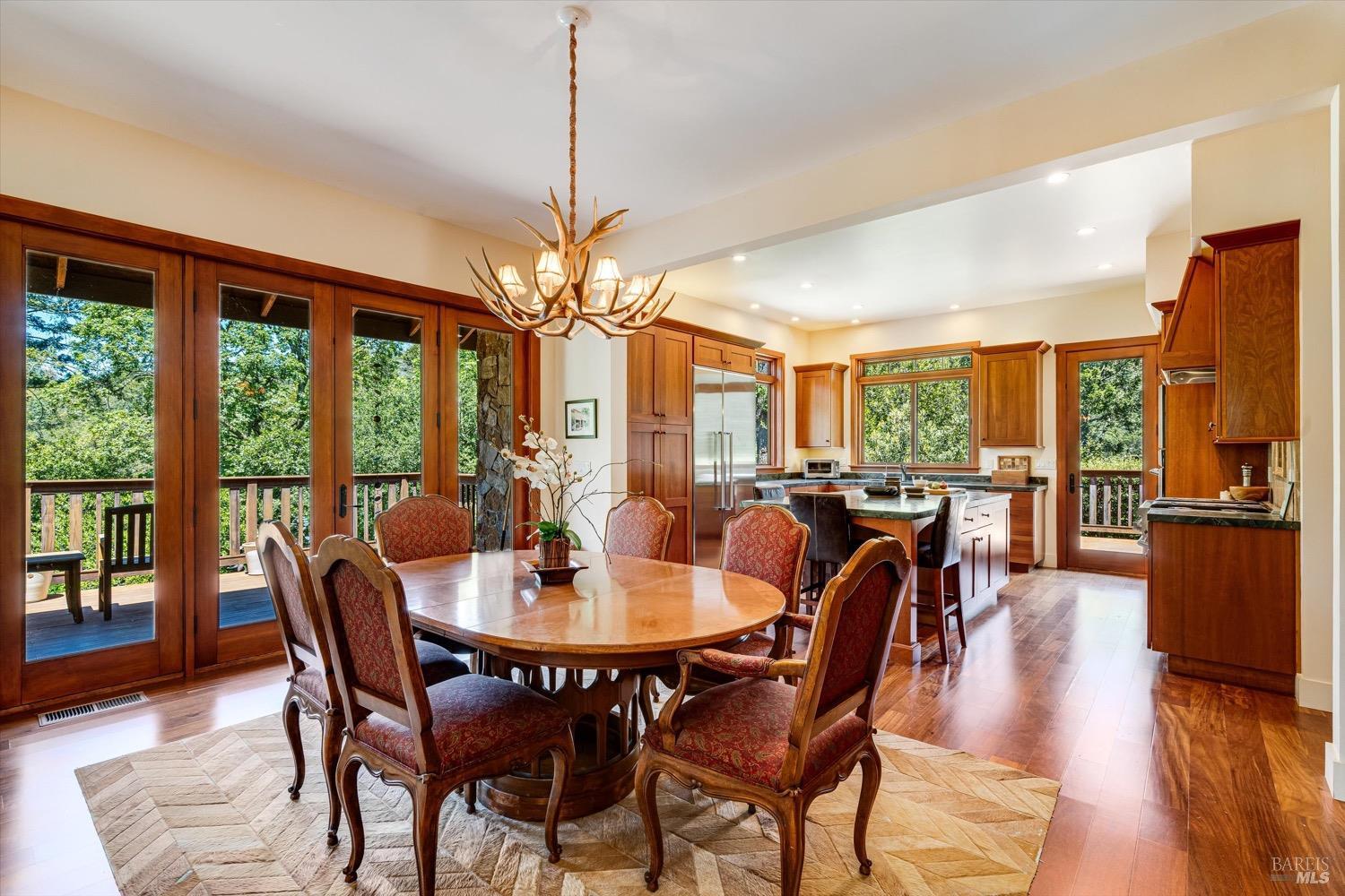 2207 Mt Veeder Road Napa, CA 94558 - Photo 8 of 36 a dining room with furniture a chandelier and wooden floor
