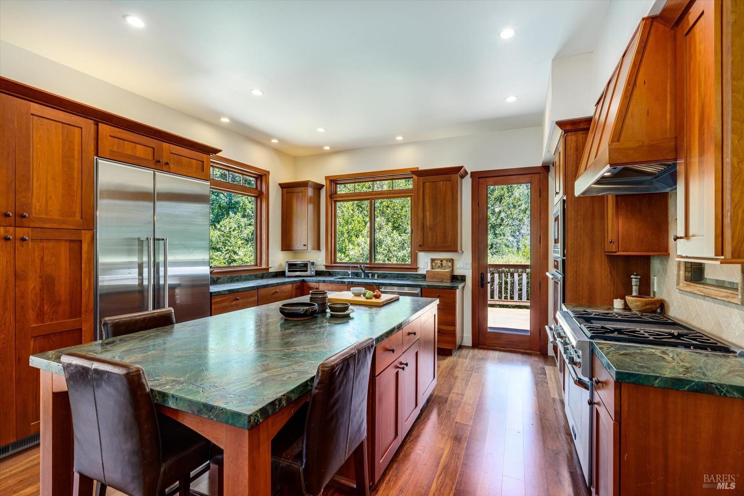 2207 Mt Veeder Road Napa, CA 94558 - Photo 9 of 36 a kitchen with a stove a sink a counter space and living room filled with furniture