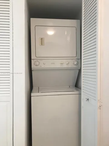 a view of a small space with wooden floor and a window