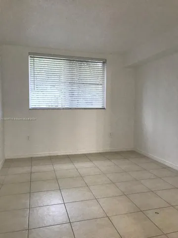 an empty room with mirror