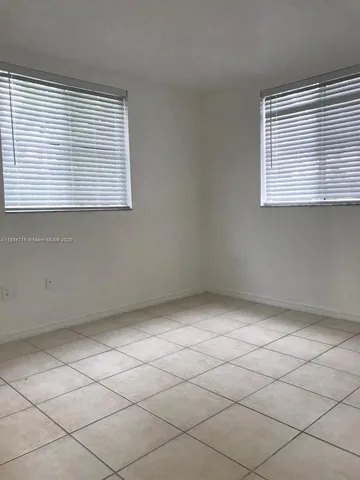 a view of a livingroom with an empty space and a window