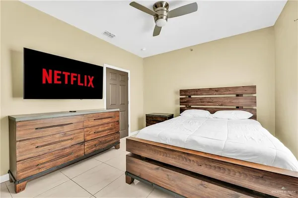a bedroom with a bed and a flat screen tv