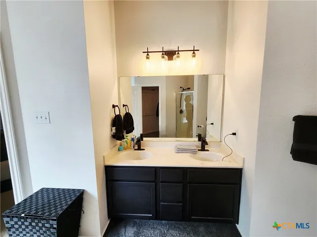 an empty room with wooden floor ceiling fan and closet area