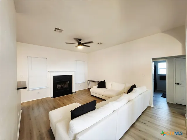 a living room with furniture and a fireplace