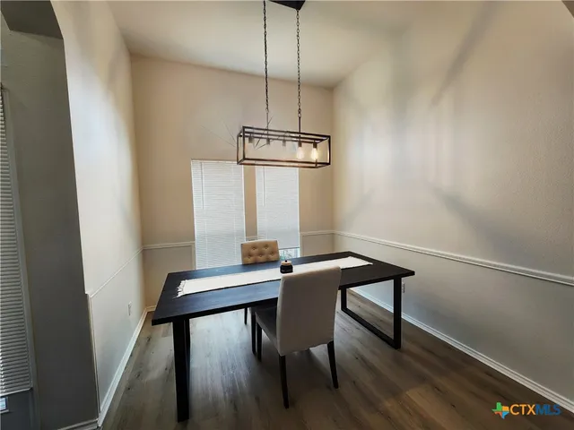 a view of a workspace with furniture and wooden floor