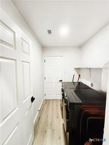 a bedroom with a bed and a flat tv screen on the dresser