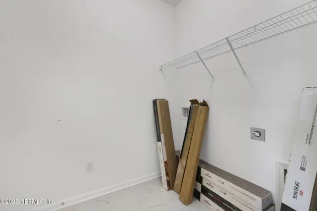 a view of storage and utility room with windows