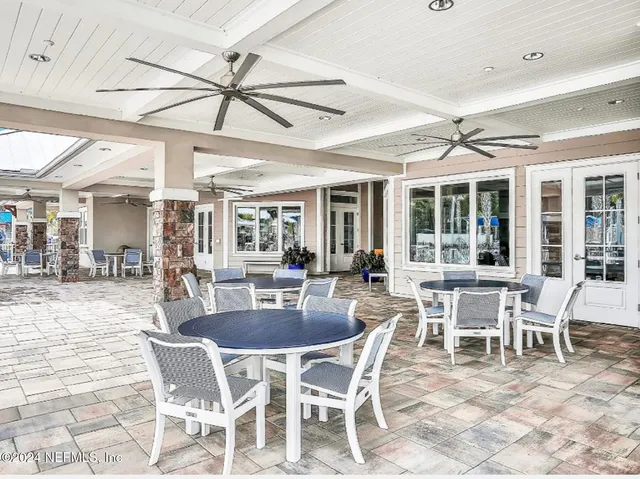 a dining area with a large glass table and chairs