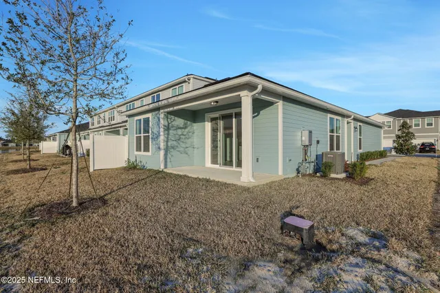 a view of a house with a backyard
