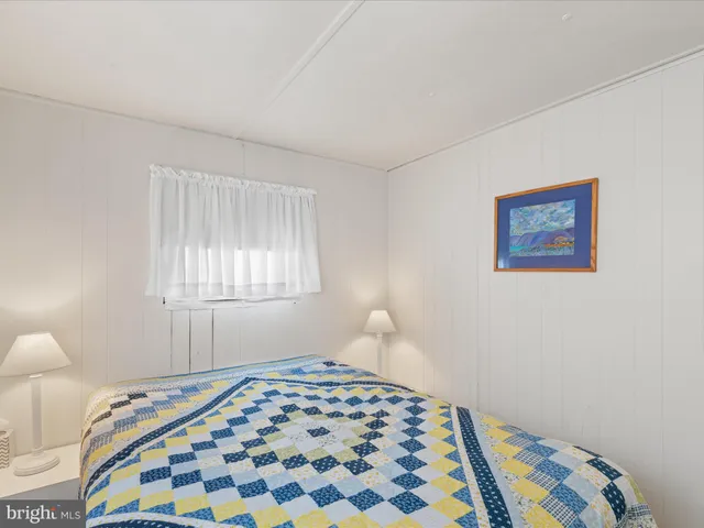 a bedroom with a bed and a lamp