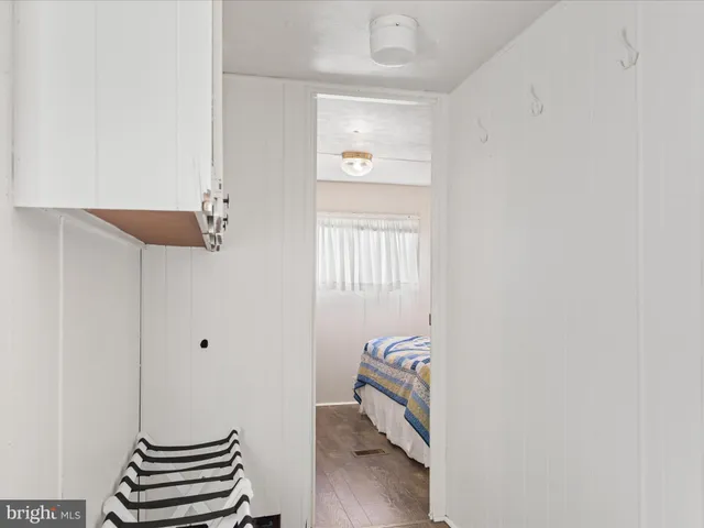 a view of room with stairs and wooden floor