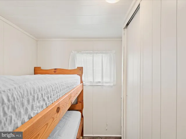 a bed sitting in a bedroom next to a window