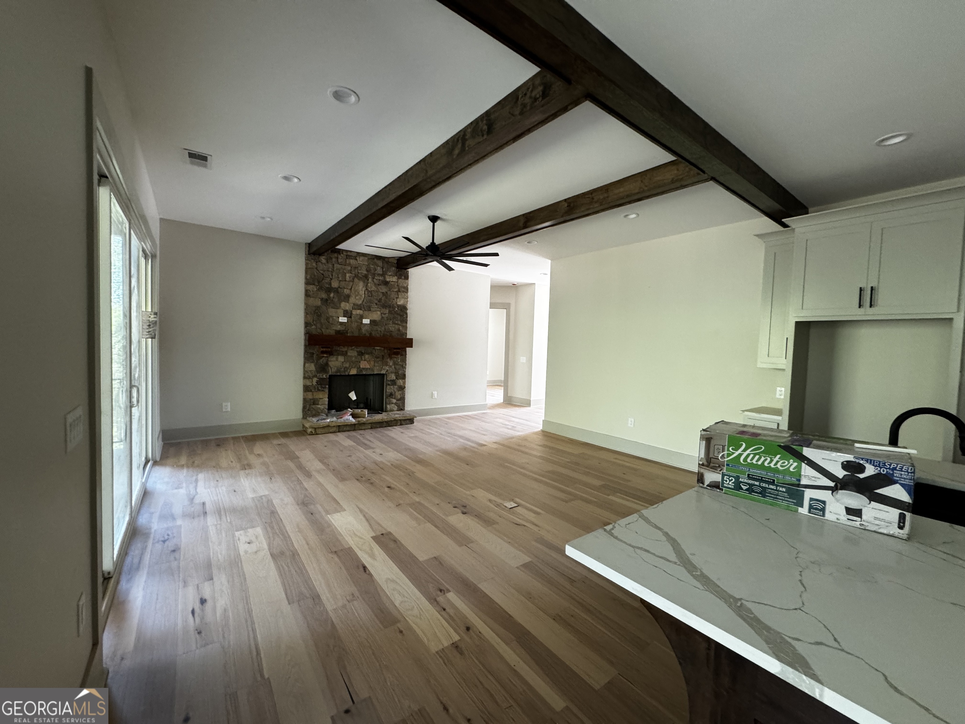260 Edgewater Trail South Toccoa, GA 30577 - Photo 5 of 37 Wood burning fireplace, hardwood floors, beamed ceiling.