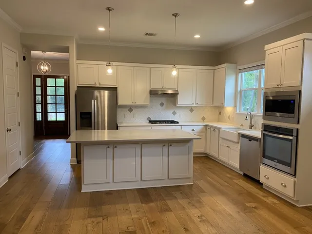 a kitchen with a sink stainless steel appliances and cabinets