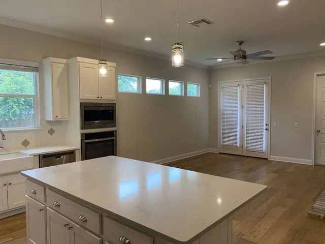 a kitchen with kitchen island a stove a sink and a refrigerator