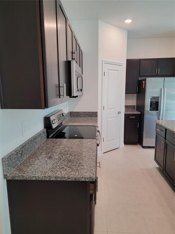 1844 Red Loop Lakeland, FL 33801 - Photo 4 of 24 a kitchen with stainless steel appliances granite countertop a sink refrigerator and microwave