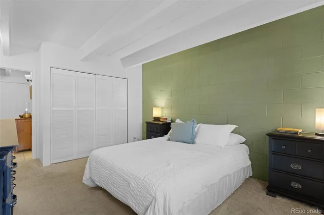 a bedroom with a bed and a night stand