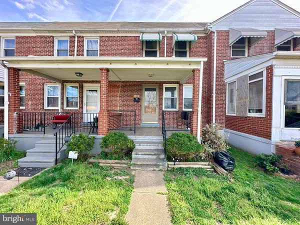 front view of a brick house with a yard