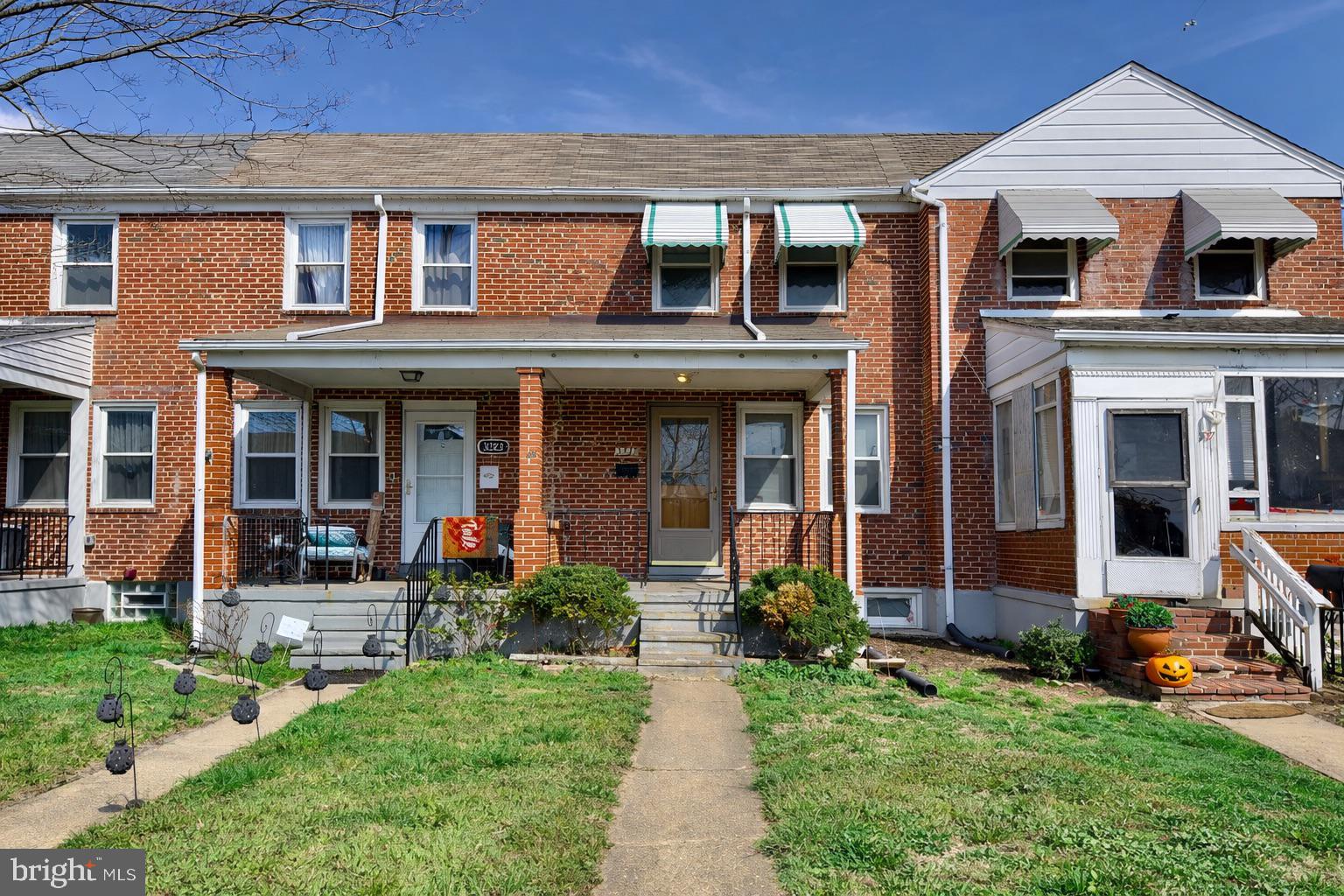3325 McShane Way Baltimore, MD 21222 - Photo 1 of 23 front view of a house with a yard