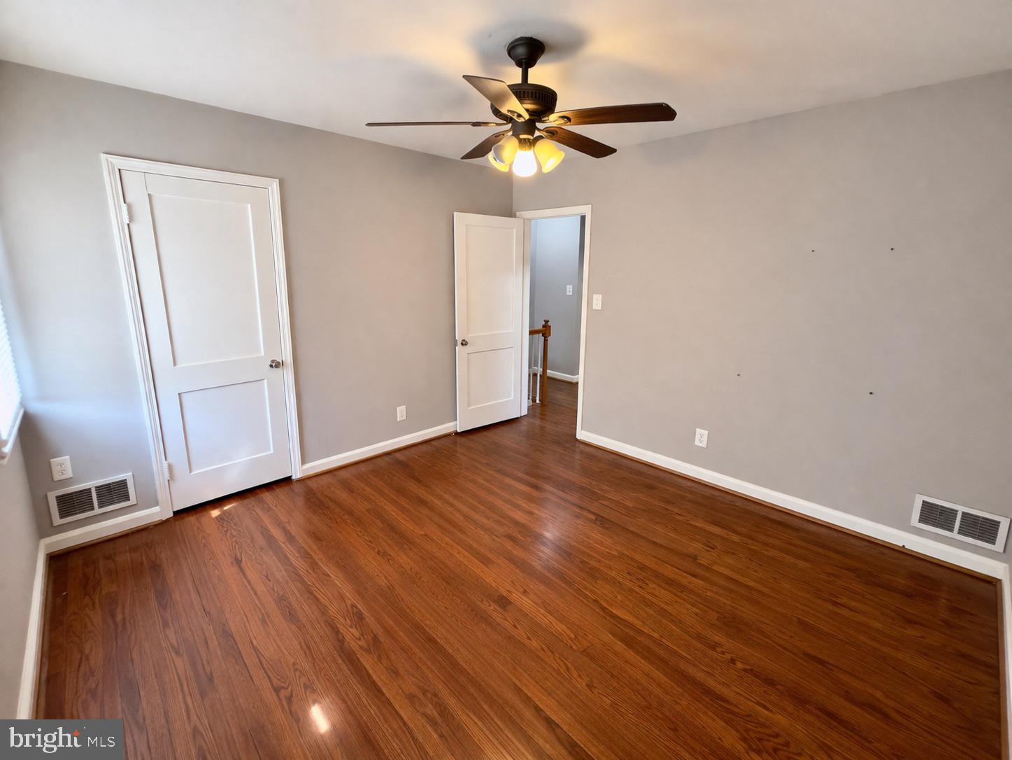 3325 McShane Way Baltimore, MD 21222 - Photo 15 of 23 a view of an empty room with wooden floor and a ceiling fan