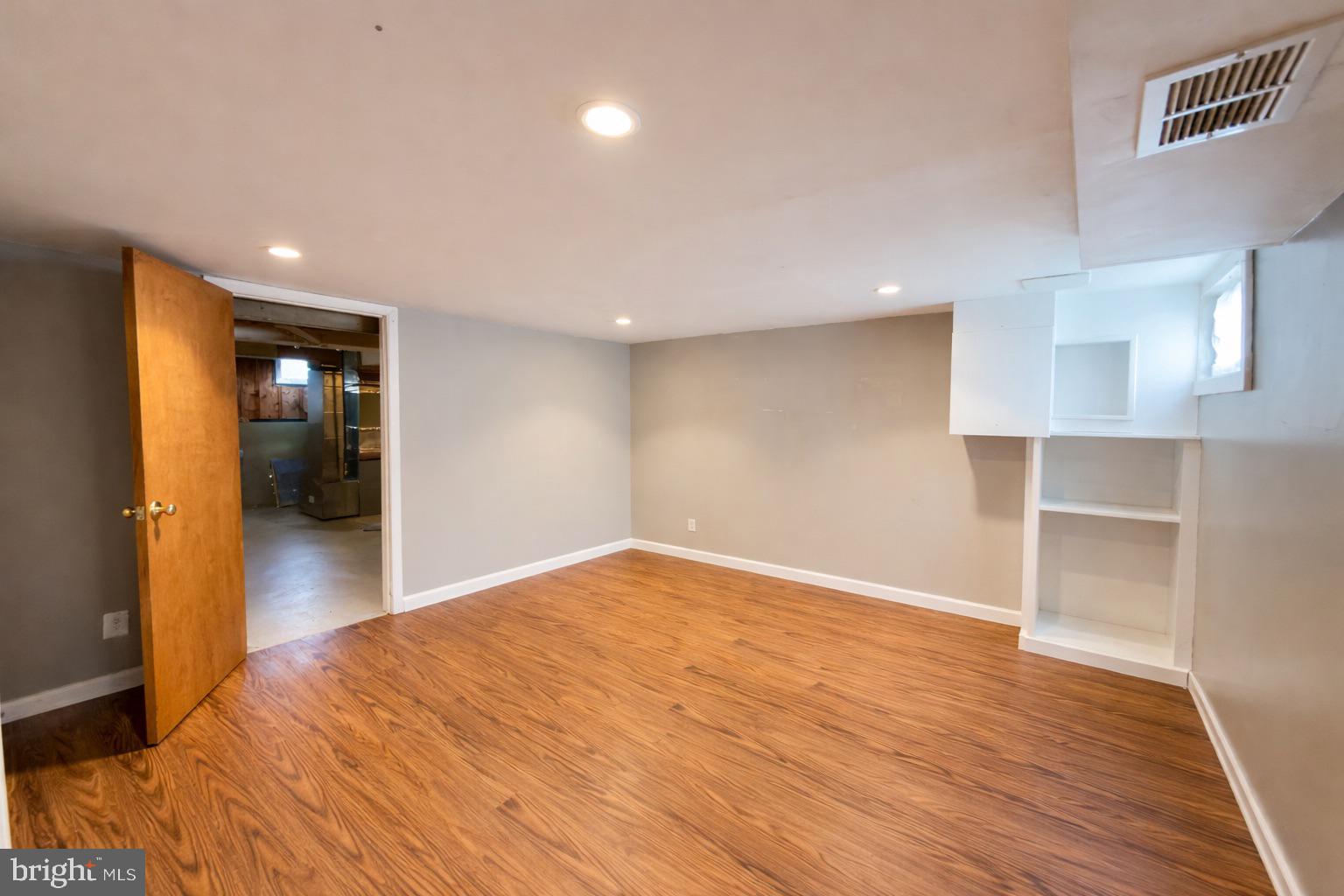 3325 McShane Way Baltimore, MD 21222 - Photo 21 of 23 a view of empty room with wooden floor