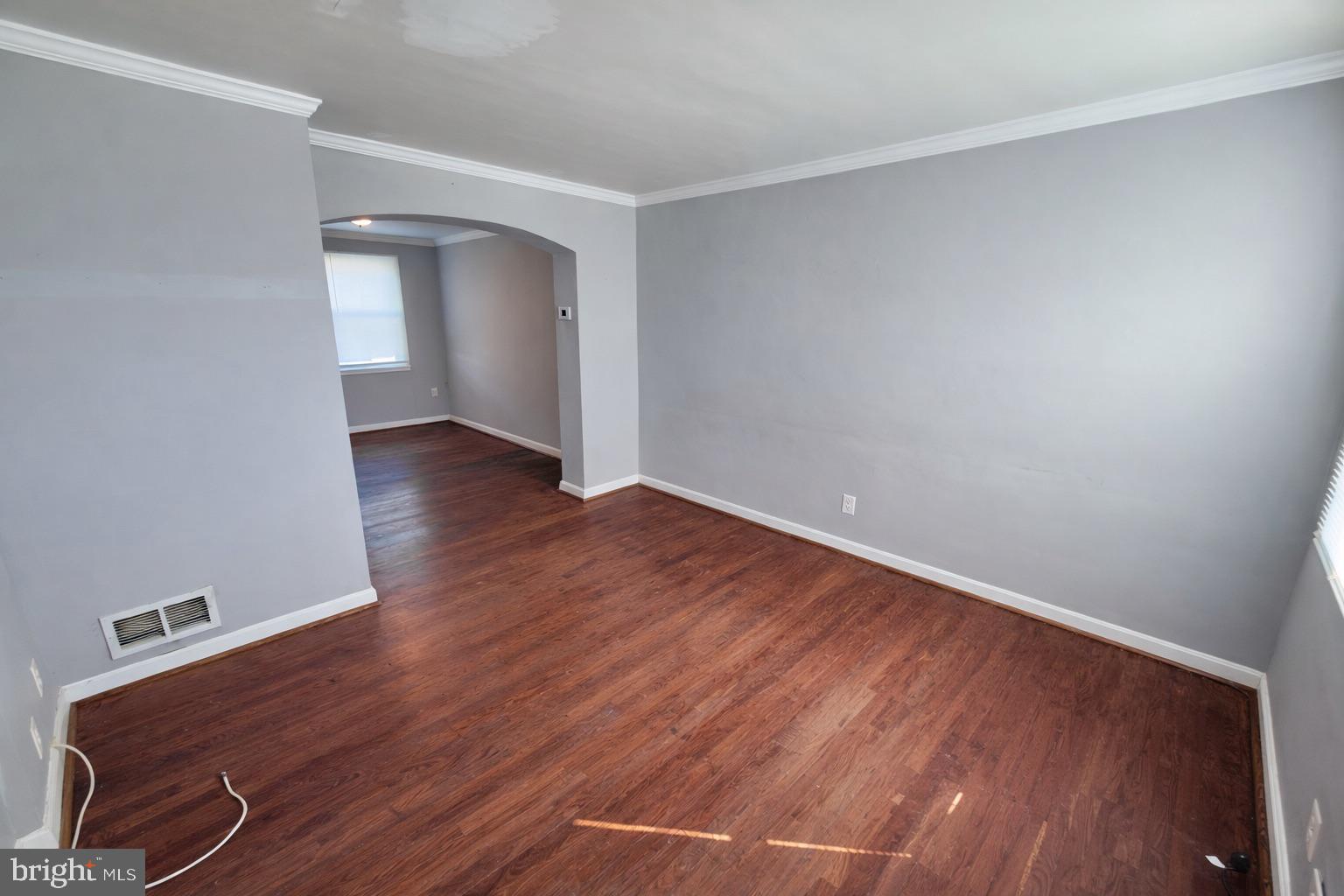 3325 McShane Way Baltimore, MD 21222 - Photo 5 of 23 a view of an empty room with wooden floor