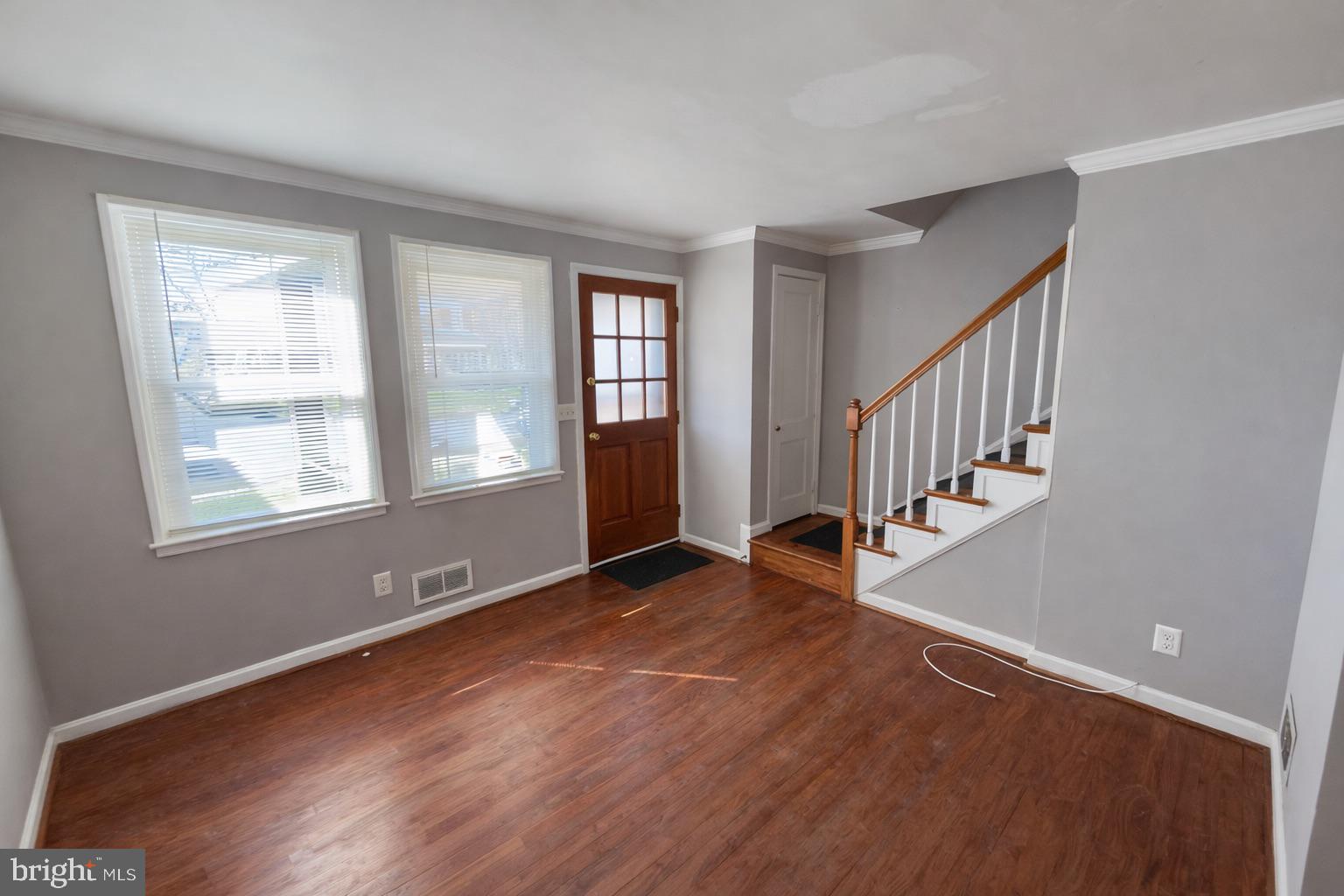 3325 McShane Way Baltimore, MD 21222 - Photo 7 of 23 a view of an empty room with wooden floor and a window