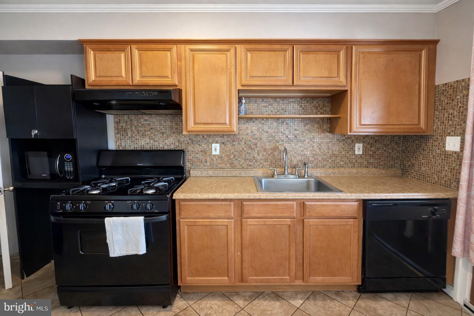 3325 McShane Way Baltimore, MD 21222 - Photo 9 of 23 a kitchen with a sink stove and cabinets