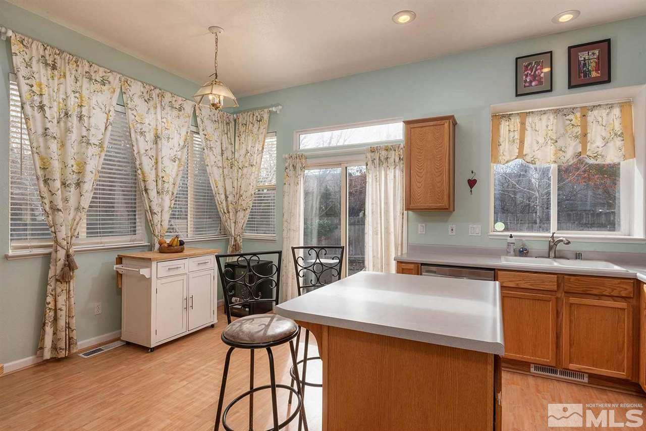 5540 Daybreak Drive Reno, NV 89523 - Photo 11 of 23 a kitchen with a sink stove and cabinets