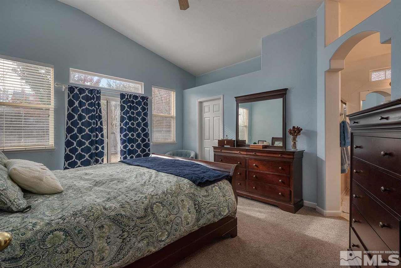 5540 Daybreak Drive Reno, NV 89523 - Photo 15 of 23 a bedroom with a bed and a dresser next to a window
