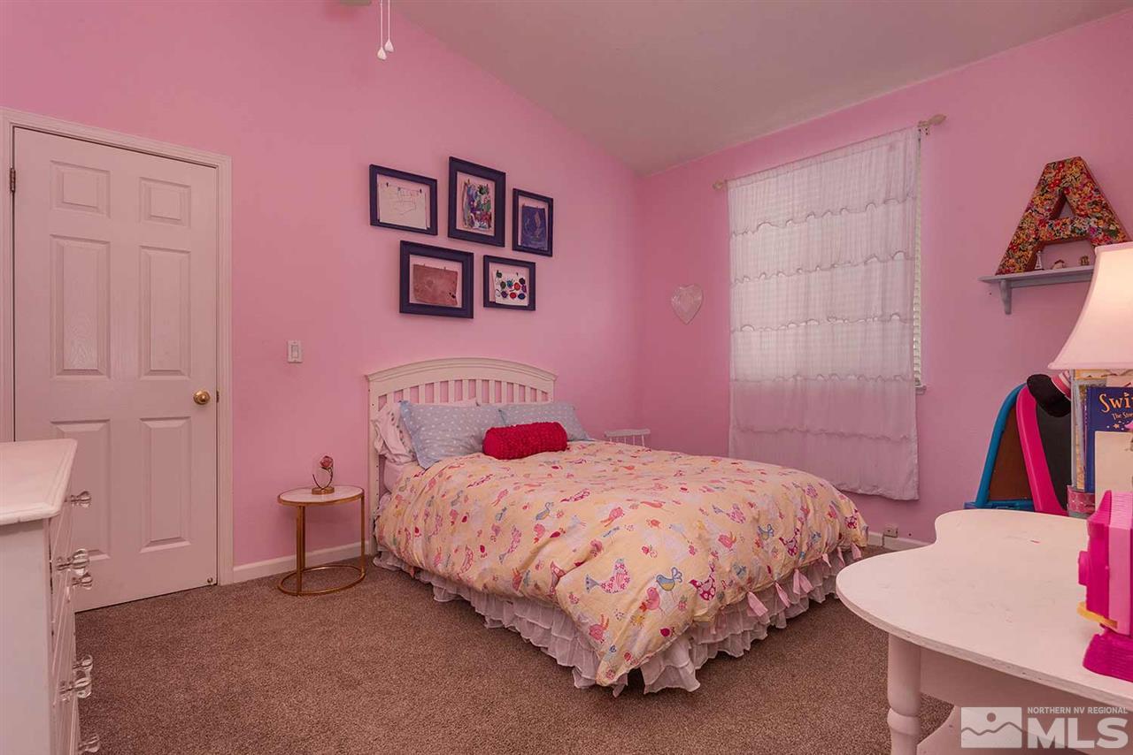 5540 Daybreak Drive Reno, NV 89523 - Photo 20 of 23 a bedroom with a bed and a mirror