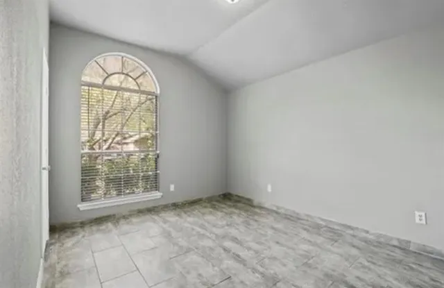 an empty room with windows and natural light