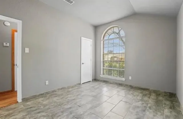 an empty room with windows and exposed view