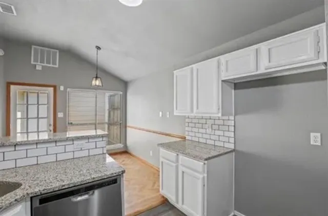 a kitchen that has a sink and a stove in it