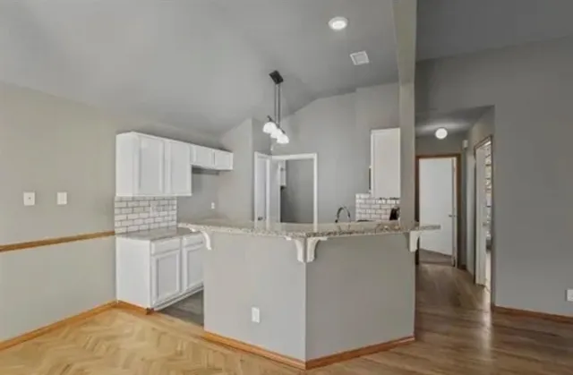 a kitchen with stainless steel appliances granite countertop a stove and a refrigerator