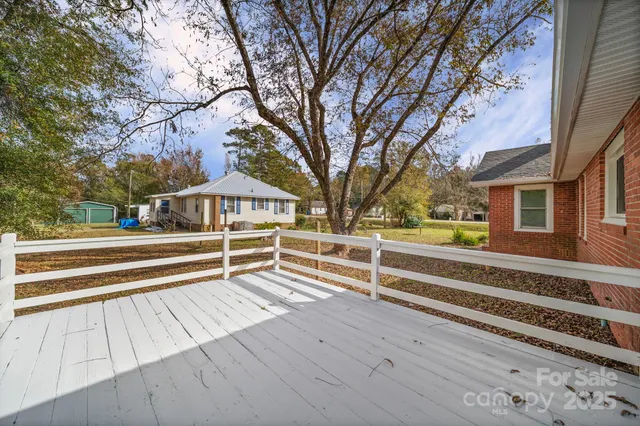 a view of backyard with deck and wooden floor