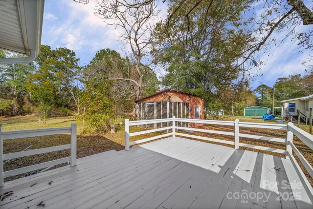 wooden floor fireplace and windows in an empty room