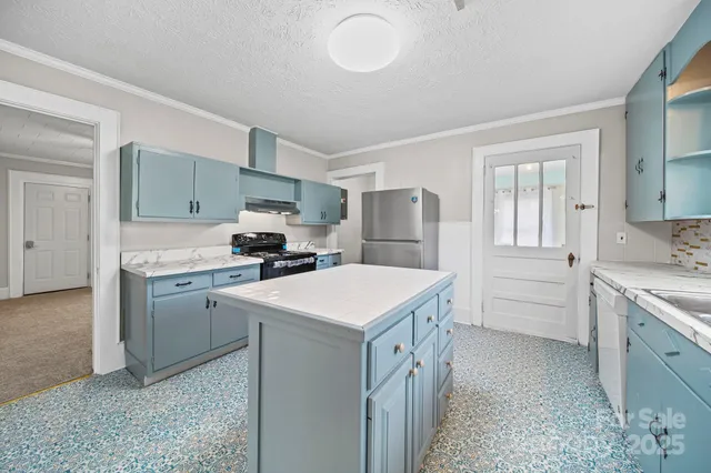 a kitchen with a stove and a refrigerator