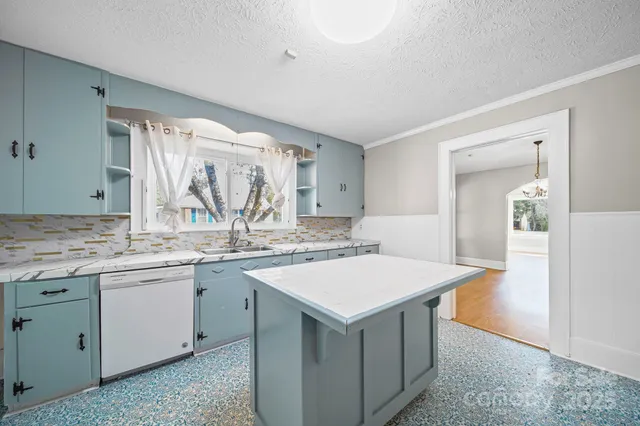 a view of washer and dryer with bathroom in the background
