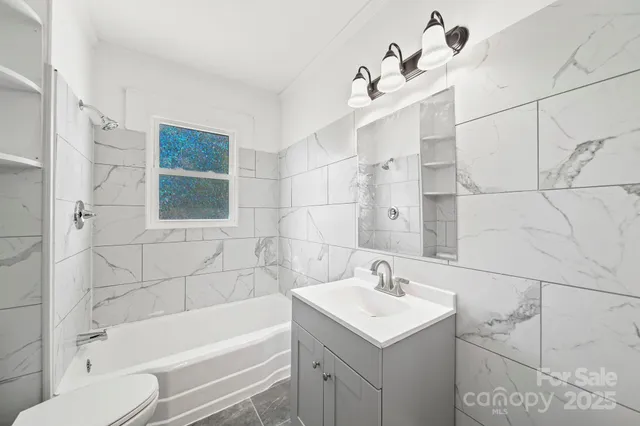 a bathroom with a sink vanity and a mirror