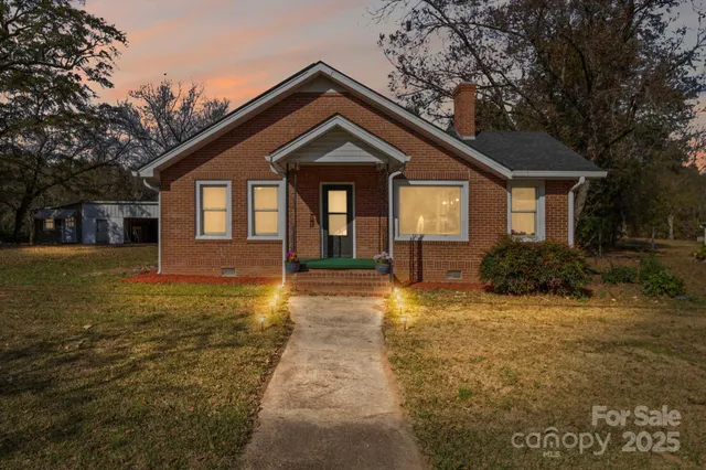 a front view of house with yard and trees