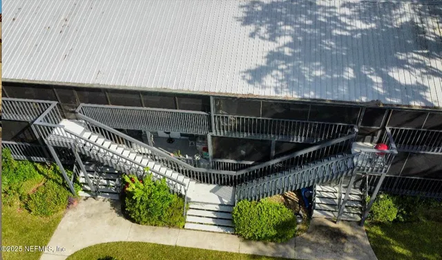 a roof deck with wooden fence and a potted plant