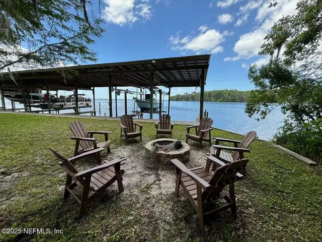 a view of a backyard with sitting area