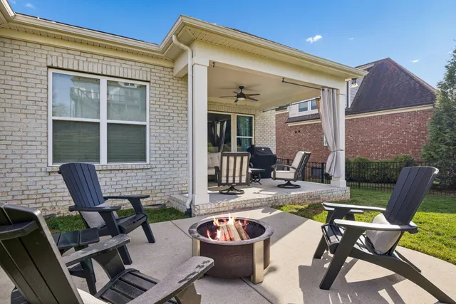 a view of a patio with dining table and chairs with barbeque grill and potted plants