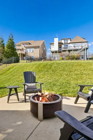 a view of a chairs and table on the terrace with a water view