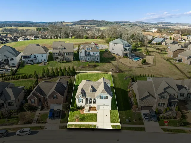 an aerial view of a house with a lake view